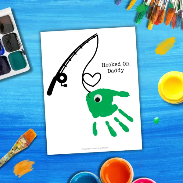 Searching for the perfect gift that will bring a joyful smile to Dad's face? Check out the delightful handprint art project called “Hooked on Daddy!” This is guaranteed to create a huge smile! Simply download the template, gather some vibrant paints, and let those little hands express their creativity like true Picassos!