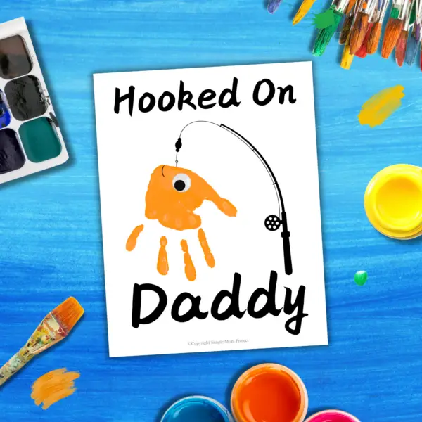 Searching for the perfect gift for Dad that will truly wow him? Introducing the handprint art project, “Hooked on Daddy!” This creative idea is guaranteed to bring a huge smile to his face! Simply print the template, grab some paint, and let those little hands create a unique masterpiece!