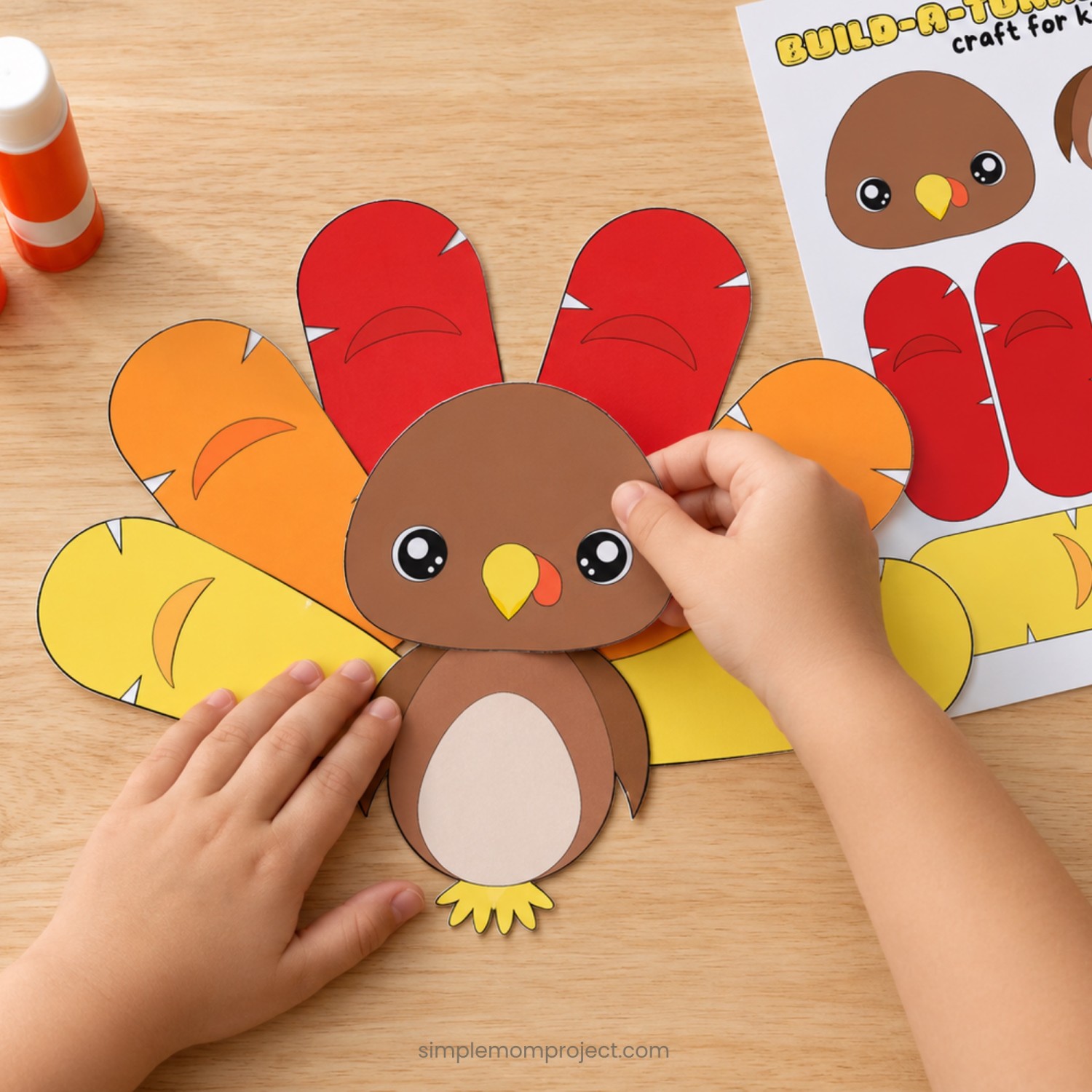 Child holding a finished Build-a-Turkey paper craft made from the printable template